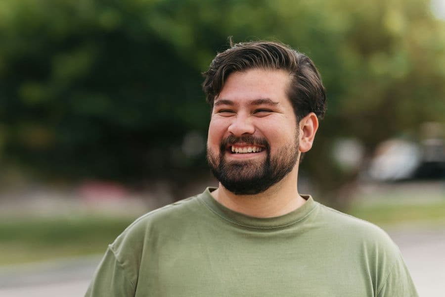 Man smiling and laughing outdoors