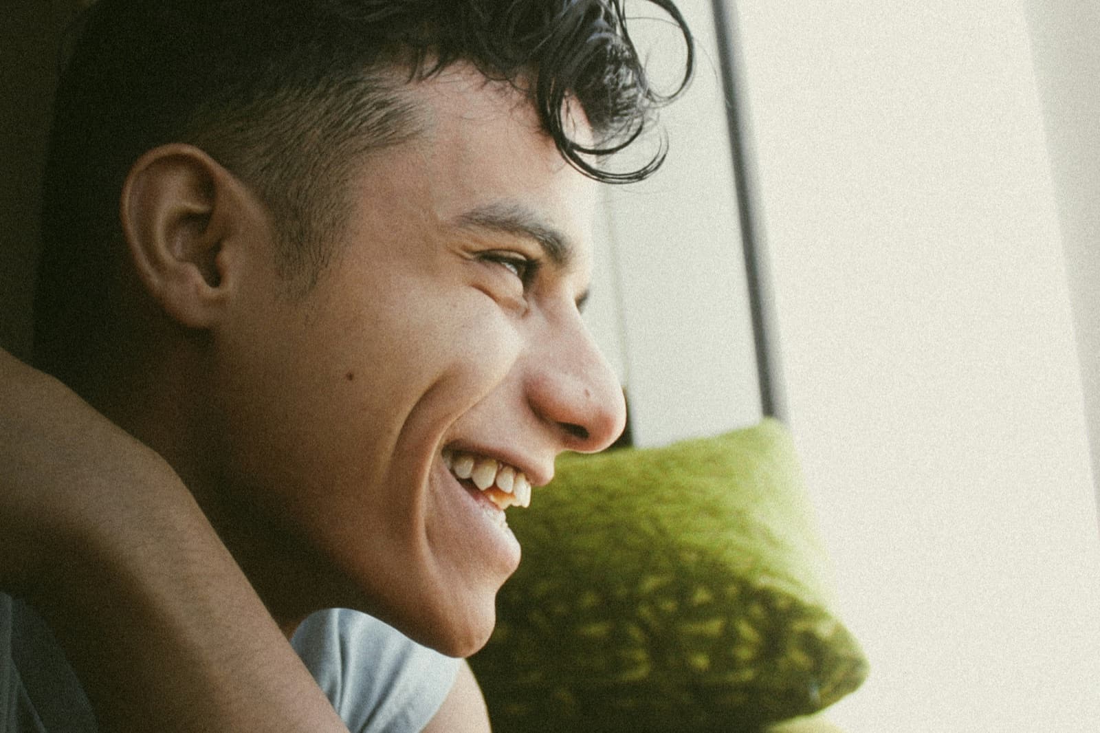 Young man smiling warmly in natural light