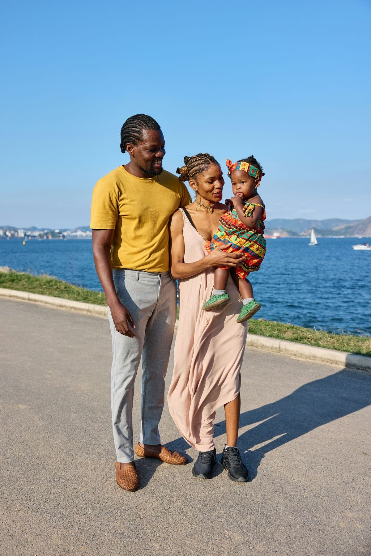 Happy family walking together by the water